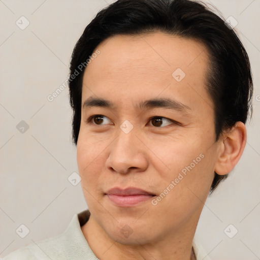 Joyful asian young-adult male with short  brown hair and brown eyes