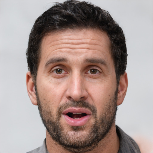 Joyful white adult male with short  brown hair and brown eyes