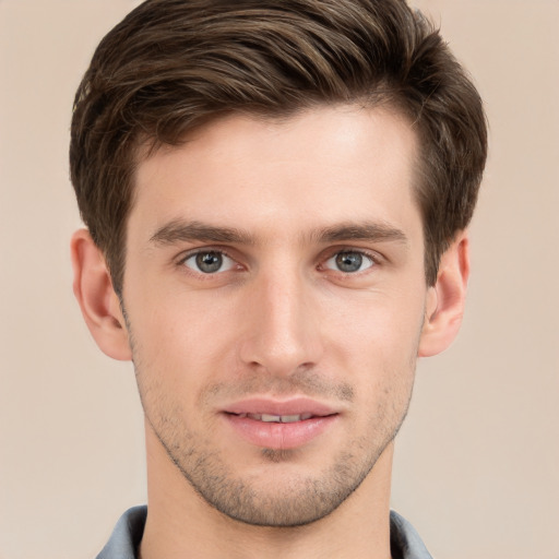 Joyful white young-adult male with short  brown hair and grey eyes