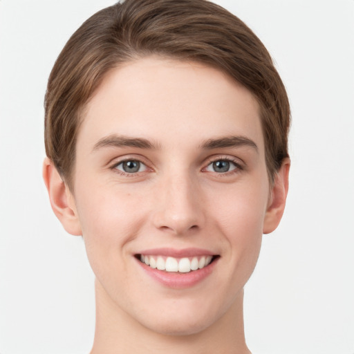 Joyful white young-adult female with short  brown hair and grey eyes