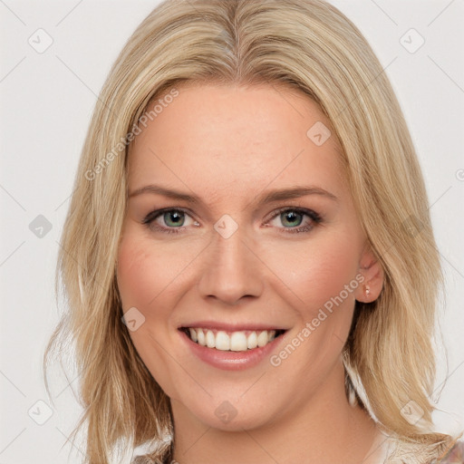 Joyful white young-adult female with long  brown hair and blue eyes