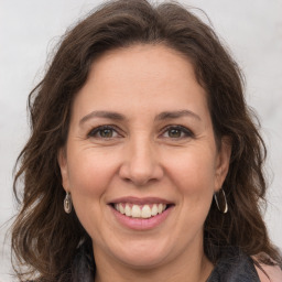 Joyful white adult female with long  brown hair and brown eyes