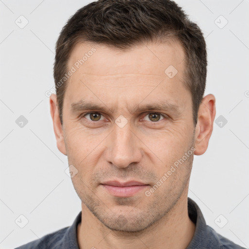 Joyful white adult male with short  brown hair and brown eyes