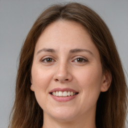 Joyful white young-adult female with long  brown hair and grey eyes