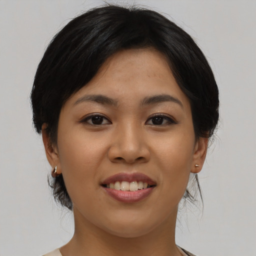 Joyful asian young-adult female with medium  black hair and brown eyes
