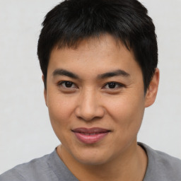 Joyful asian young-adult male with short  brown hair and brown eyes