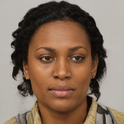 Neutral black young-adult female with long  brown hair and brown eyes