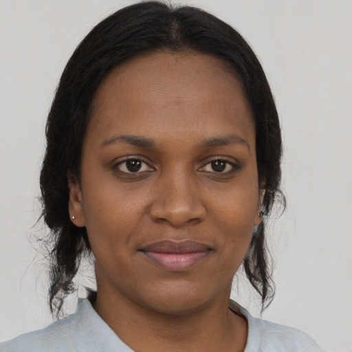 Joyful black young-adult female with medium  brown hair and brown eyes