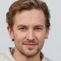 Joyful white adult male with short  brown hair and grey eyes