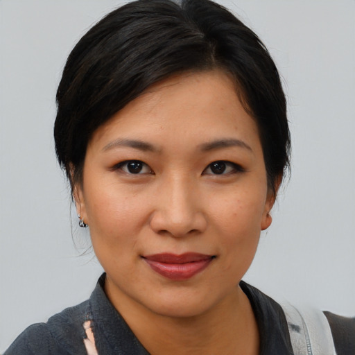 Joyful latino young-adult female with medium  black hair and brown eyes