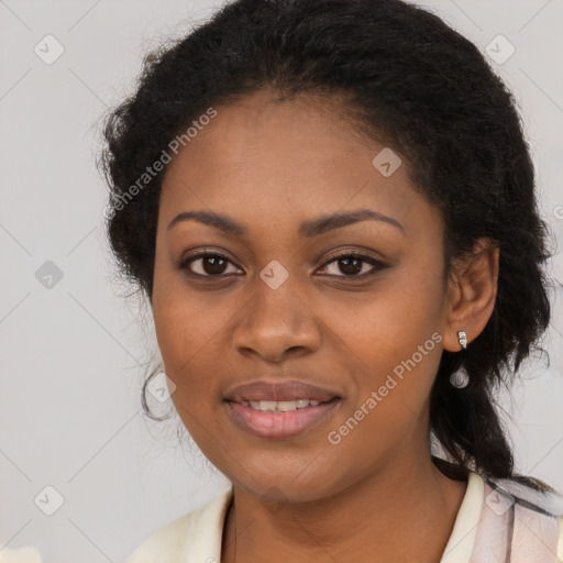 Joyful black young-adult female with long  brown hair and brown eyes