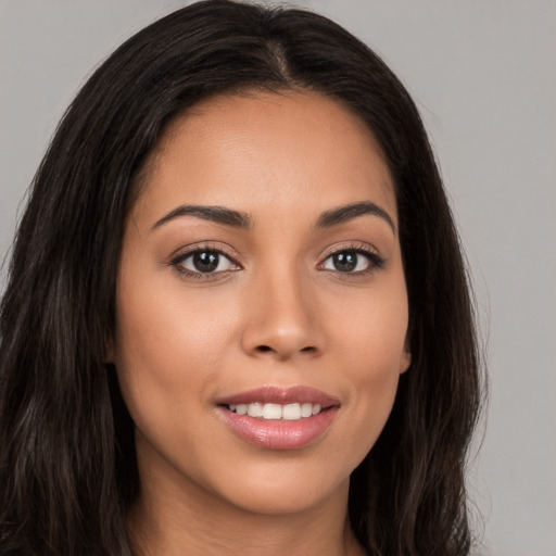 Joyful white young-adult female with long  brown hair and brown eyes