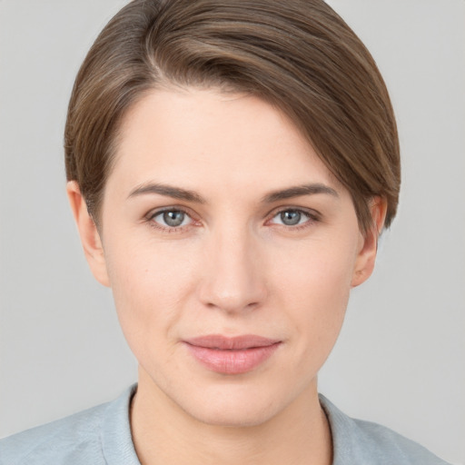 Joyful white young-adult female with short  brown hair and grey eyes