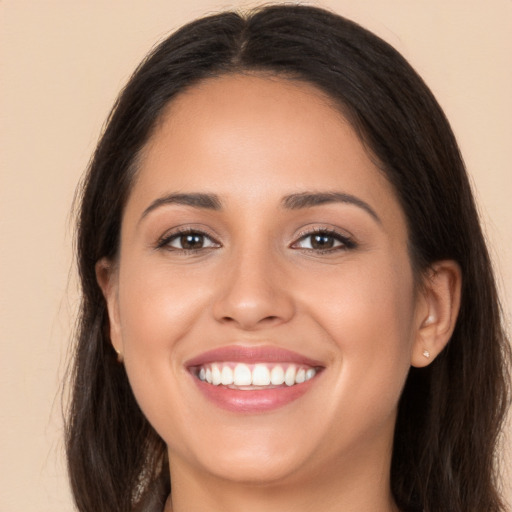 Joyful white young-adult female with long  brown hair and brown eyes