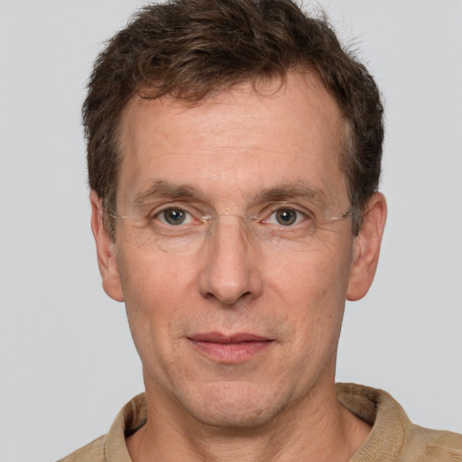 Joyful white adult male with short  brown hair and grey eyes