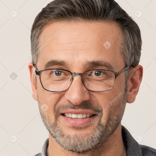 Joyful white adult male with short  brown hair and brown eyes