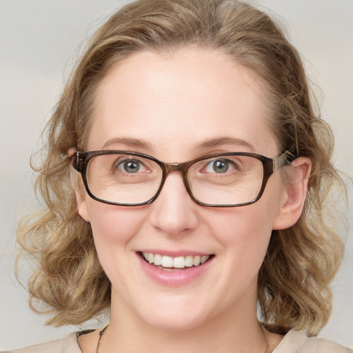 Joyful white young-adult female with medium  brown hair and blue eyes