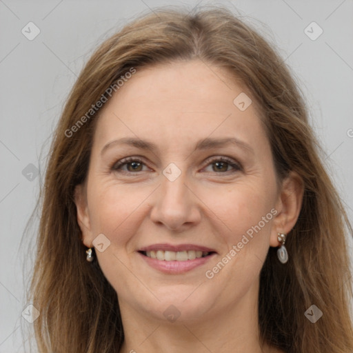 Joyful white adult female with long  brown hair and grey eyes