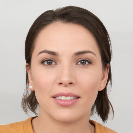 Joyful white young-adult female with medium  brown hair and brown eyes