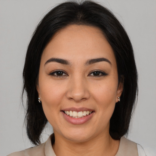 Joyful latino young-adult female with medium  brown hair and brown eyes