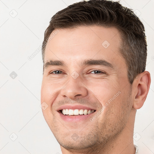 Joyful white young-adult male with short  brown hair and brown eyes