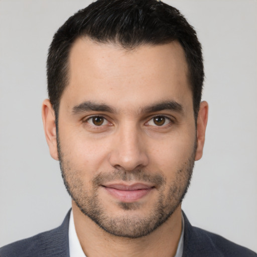 Joyful white young-adult male with short  black hair and brown eyes