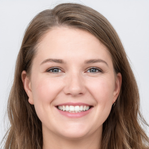 Joyful white young-adult female with long  brown hair and grey eyes