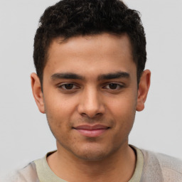 Joyful latino young-adult male with short  brown hair and brown eyes