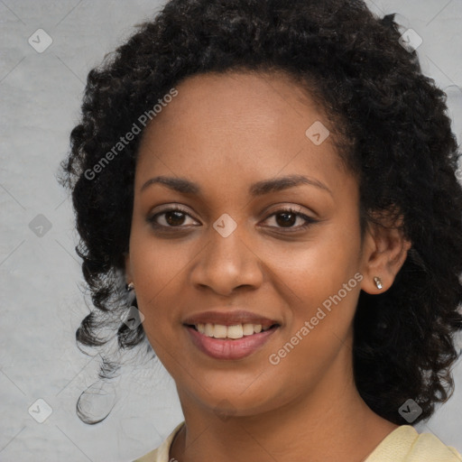 Joyful black young-adult female with long  black hair and brown eyes