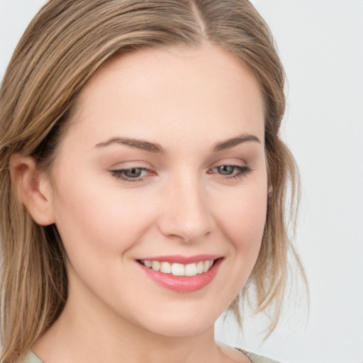 Joyful white young-adult female with long  brown hair and blue eyes