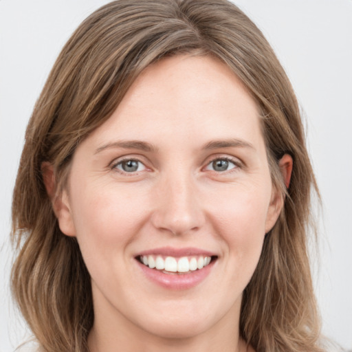 Joyful white young-adult female with long  brown hair and grey eyes