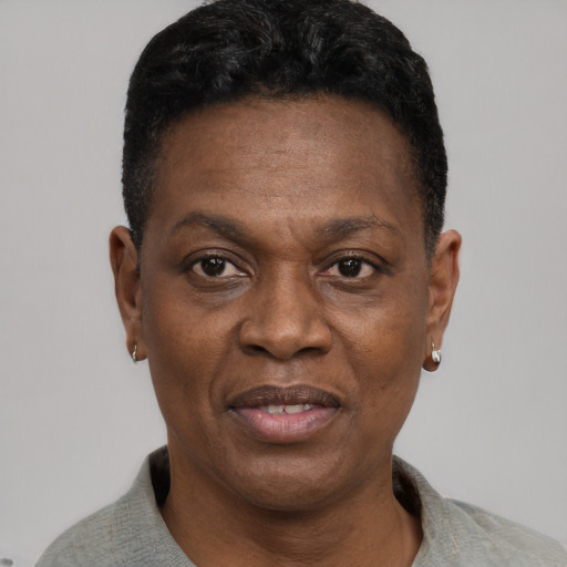 Joyful black adult male with short  black hair and brown eyes