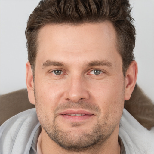 Joyful white adult male with short  brown hair and brown eyes