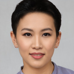 Joyful asian young-adult female with short  black hair and brown eyes