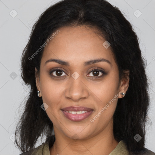 Joyful black young-adult female with long  brown hair and brown eyes