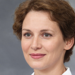 Joyful white adult female with medium  brown hair and brown eyes