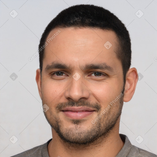 Joyful white young-adult male with short  black hair and brown eyes