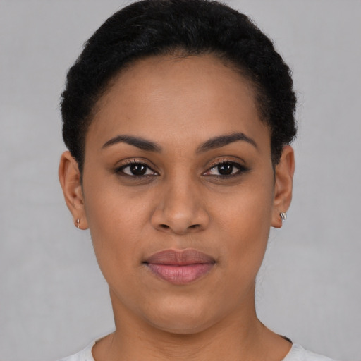 Joyful latino young-adult female with short  black hair and brown eyes