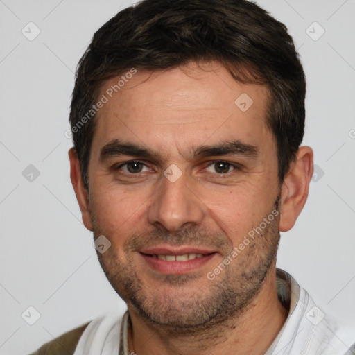 Joyful white adult male with short  brown hair and brown eyes