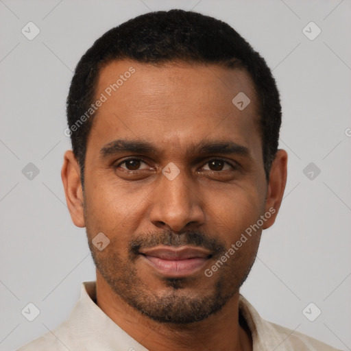 Joyful black young-adult male with short  black hair and brown eyes