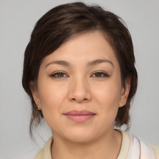 Joyful asian young-adult female with medium  brown hair and brown eyes
