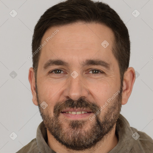 Joyful white adult male with short  brown hair and brown eyes