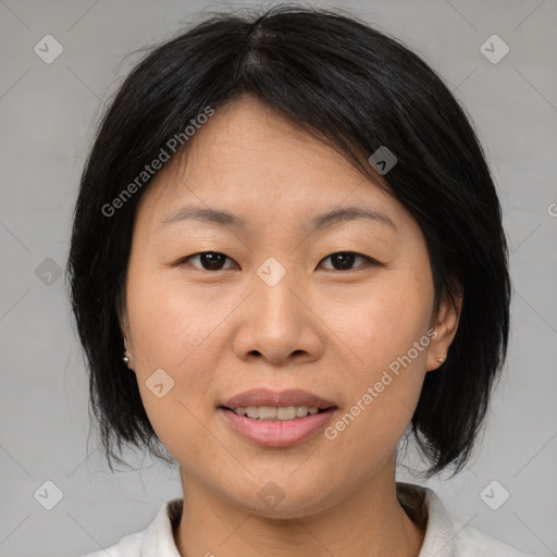 Joyful asian young-adult female with medium  brown hair and brown eyes