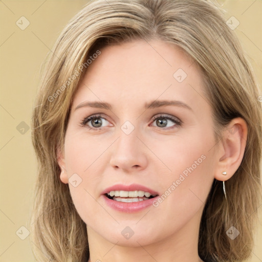 Joyful white young-adult female with long  brown hair and green eyes