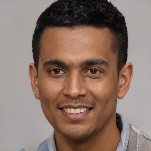 Joyful latino young-adult male with short  black hair and brown eyes