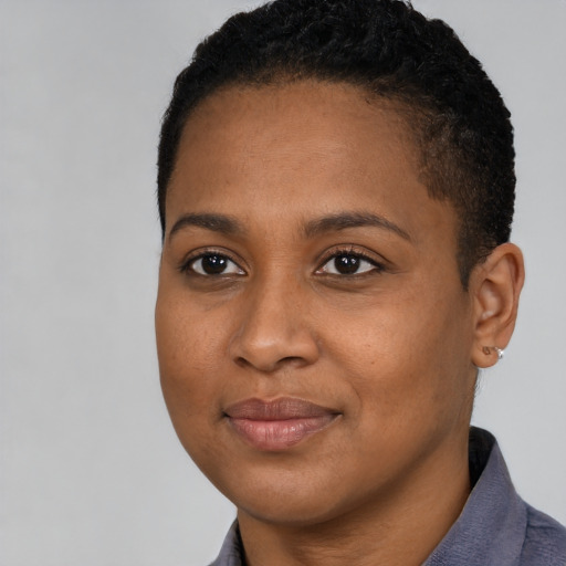 Joyful black young-adult female with short  brown hair and brown eyes