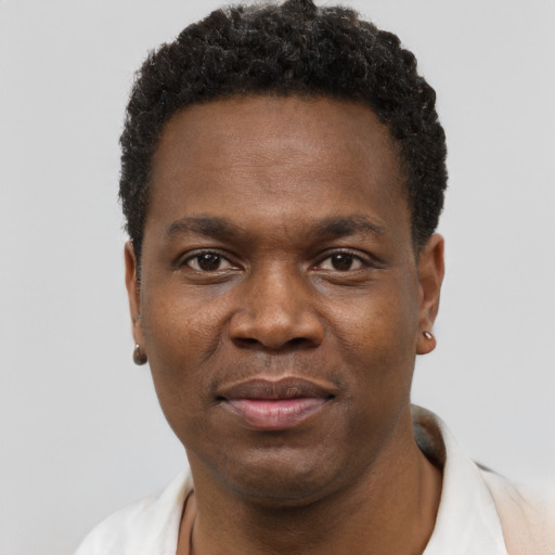 Joyful black young-adult male with short  black hair and brown eyes