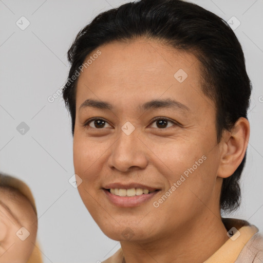 Joyful latino adult female with medium  brown hair and brown eyes