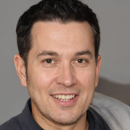 Joyful white adult male with short  brown hair and brown eyes