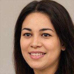 Joyful latino young-adult female with long  brown hair and brown eyes